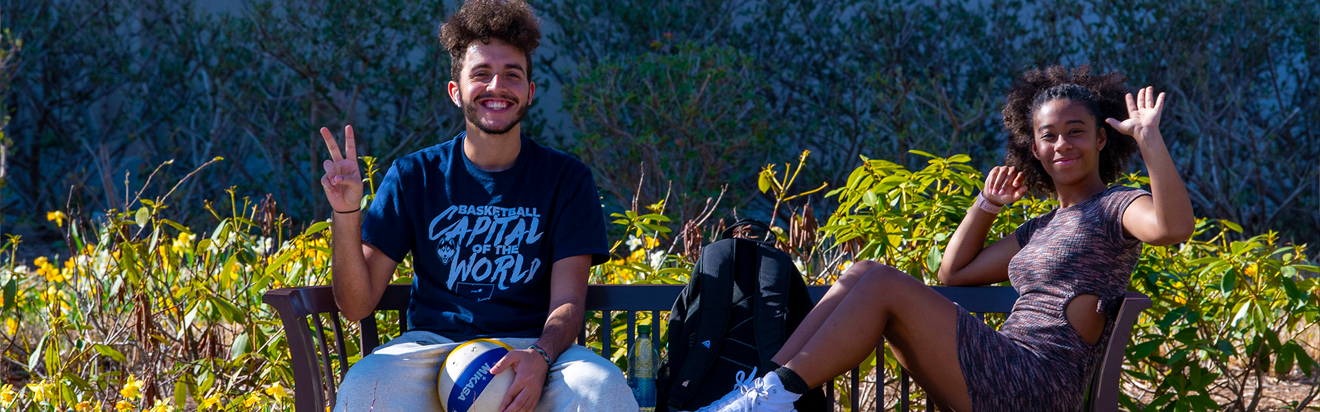 two uconn students sitting on a bench